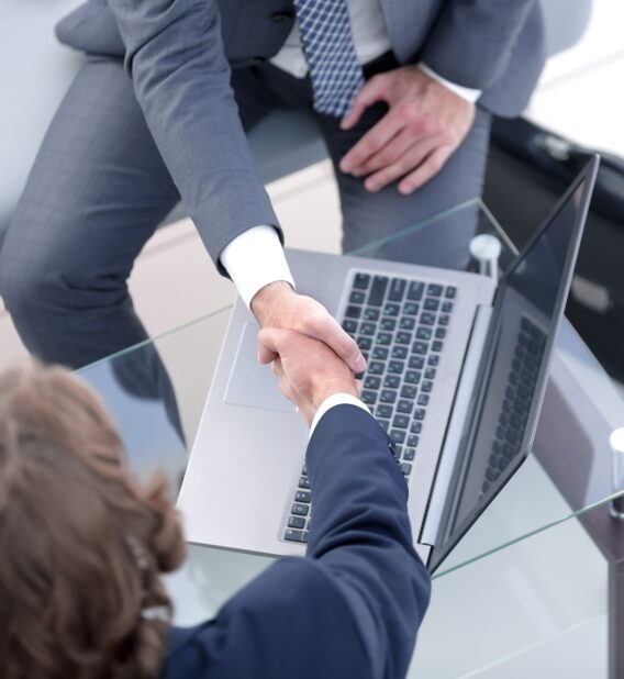 Abovo Media - handshake-business-partners-desk